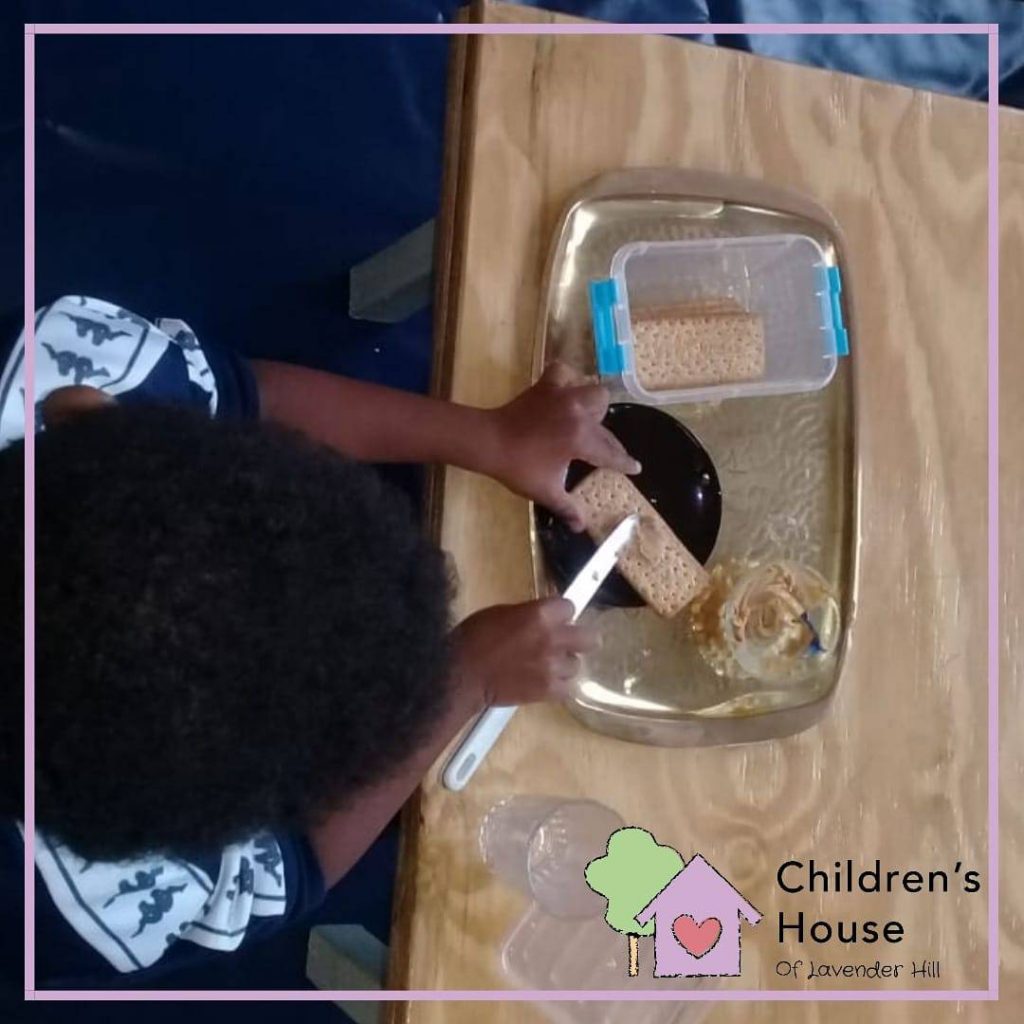 Preparing a healthy snack of Provitas and peanut butter.